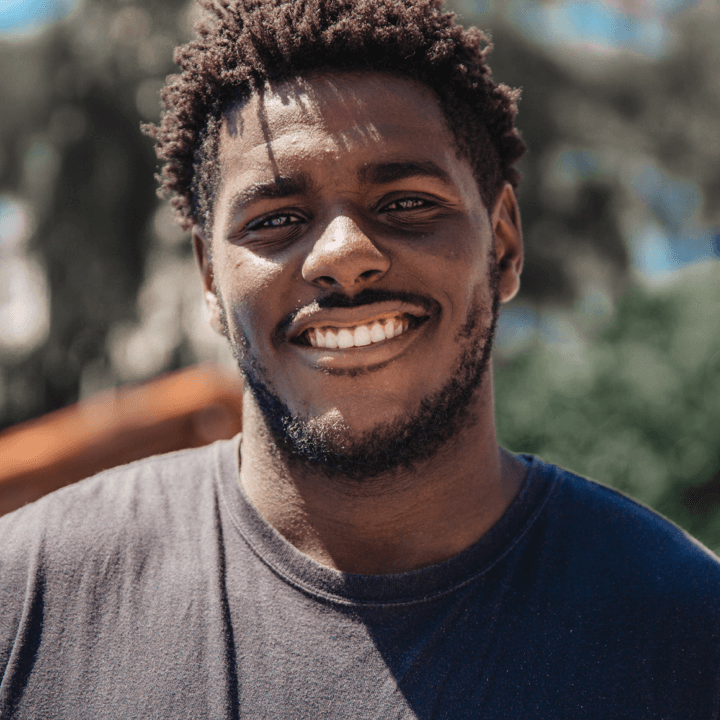 Image of man outside in the sun smiling